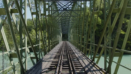 railroad track over historic metal bridge photo