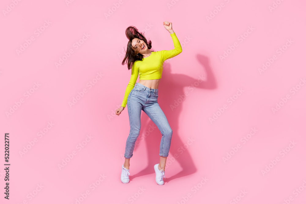 Full body photo of adorable slim sweet girl satisfied new trendy outfit good mood raise arm enjoy dance isolated on pink color background