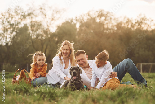 Cute dog. Family have weekend outdoors at summertime together
