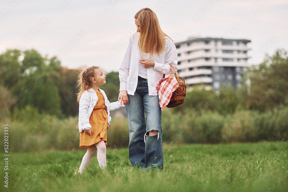 Mother with her young daughter is having a walk outdoors Mother with her young daughter is having a walk outdoors