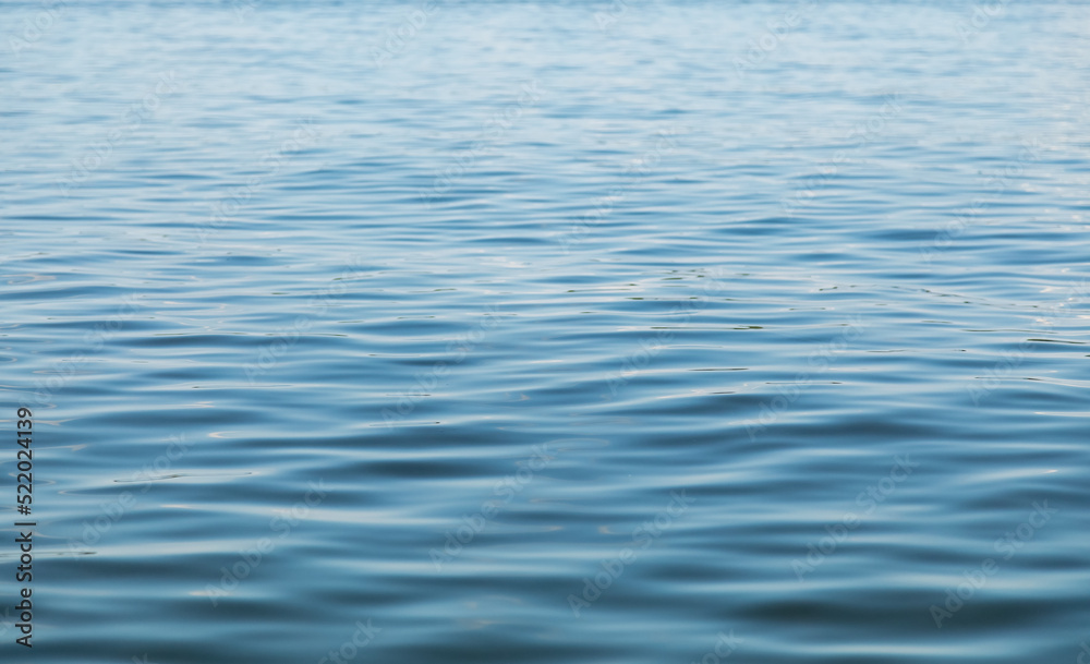 Water surface. The texture of the waves. Large water surface with small waves on the surface Water surface. The texture of the waves. Large water surface with small waves on the surface