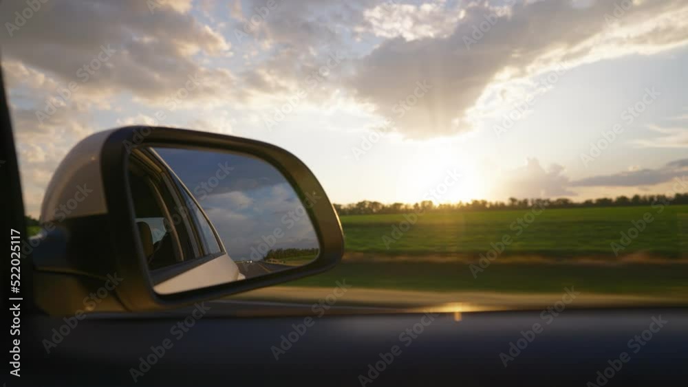 View from the side window of a car driving fast along the highway ...
