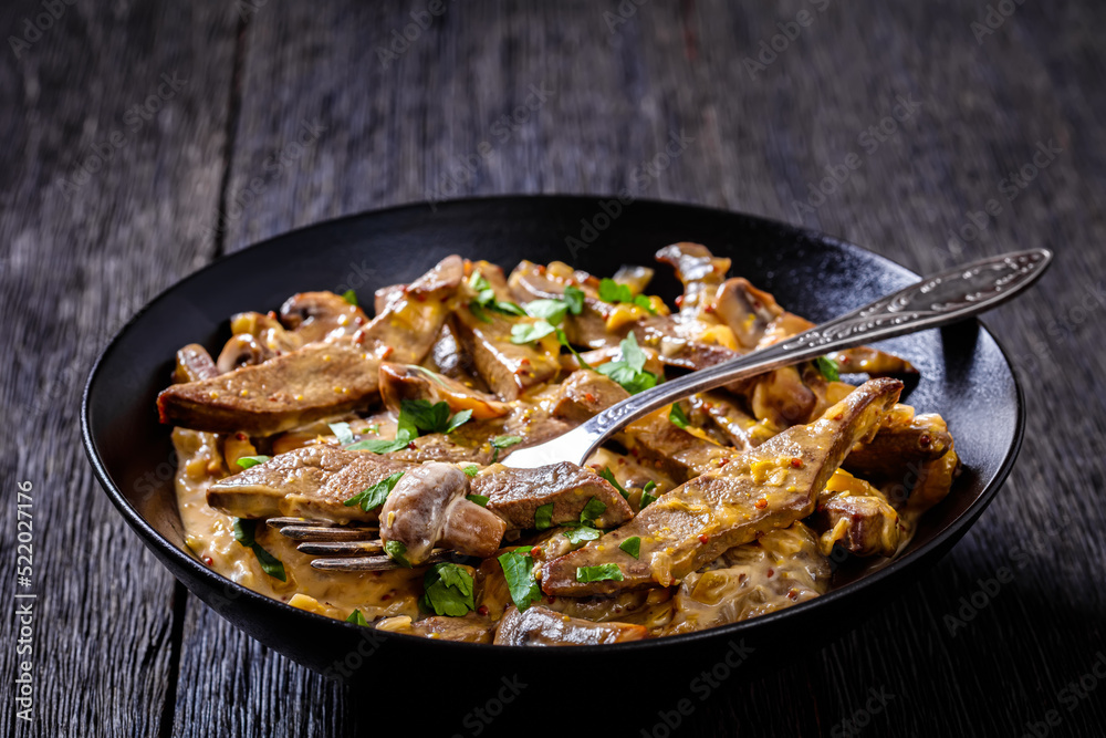 liver stroganoff in black bowl, top view liver stroganoff in black bowl, top view