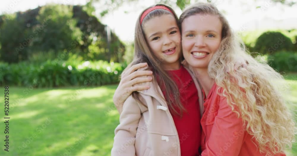 Video portrait of happy caucasian mother embracing with smiling daughter in garden Video portrait of happy caucasian mother embracing with smiling daughter in garden
