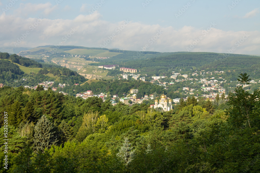 Panoramic view of the green valley among the hills and the horizon with a cloudy sky and a space to copy from the observation deck of Kislovodsk russia