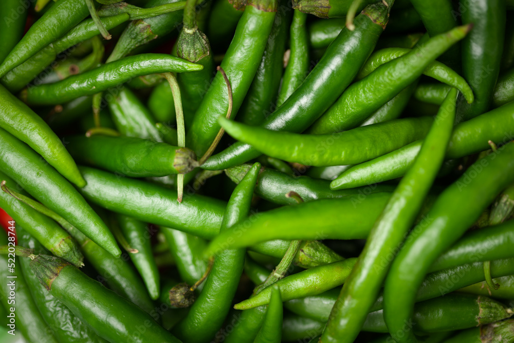 Close-Up of of Indian Organic fresh green chili ( Capsicum annuum ) as full frame background Close-Up of of Indian Organic fresh green chili ( Capsicum annuum ) as full frame background