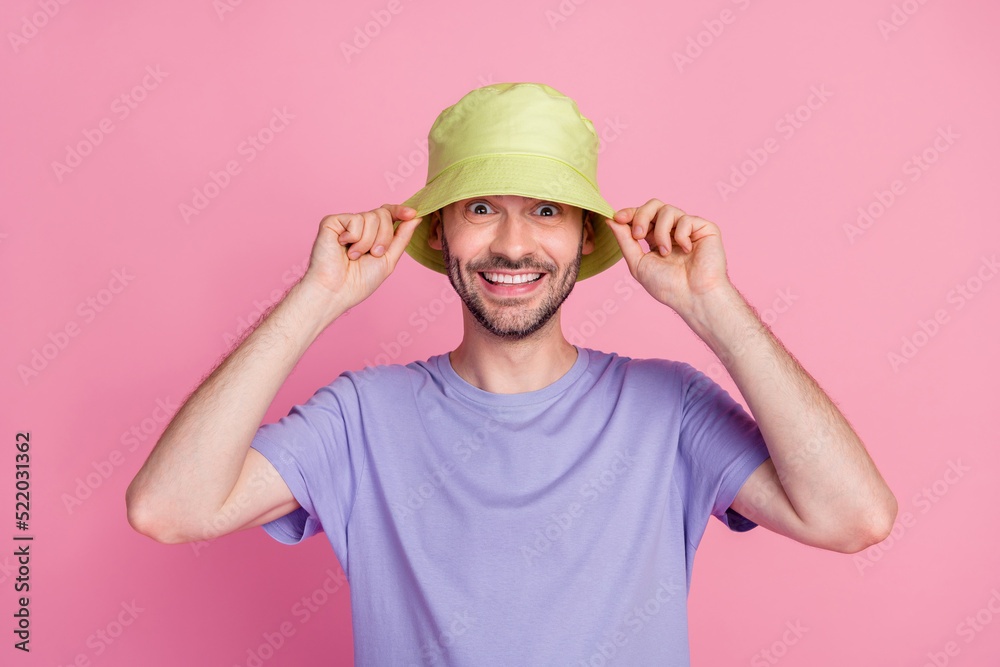 Photo of joyful guy arm finger touch fashionable headwear ready have rest sea time vacation summer relax isolated on pink color background