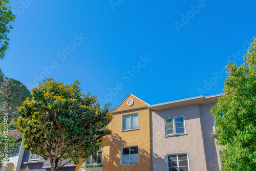 Facade of adjacent houses with painted stucco walls at San Francisco, CA