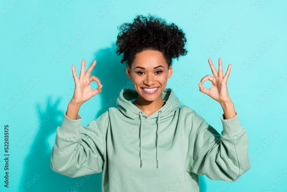 Portrait of charming positive lady hands fingers demonstrate okey symbol isolated on turquoise color background Portrait of charming positive lady hands fingers demonstrate okey symbol isolated on turquoise color background
