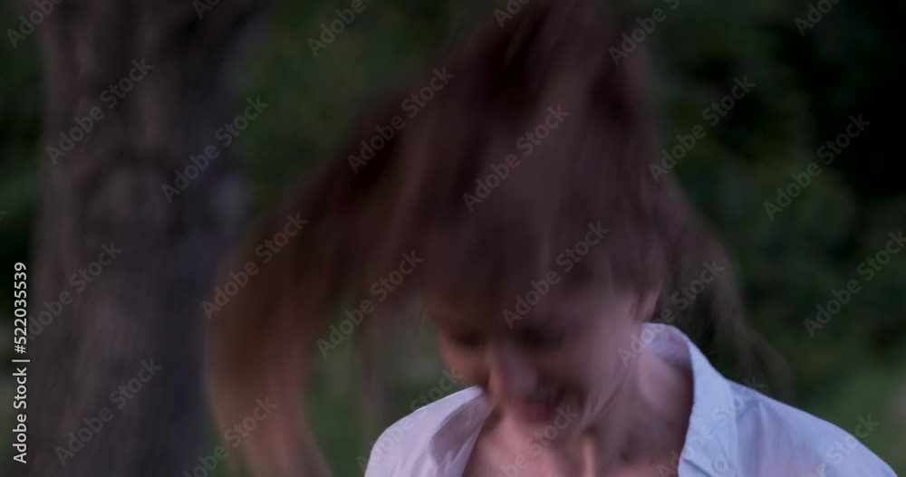Girl with long hair leans forward sharply and raises her head. Brunette brandishes hair. Girl with long hair leans forward sharply and raises her head. Brunette brandishes hair.
