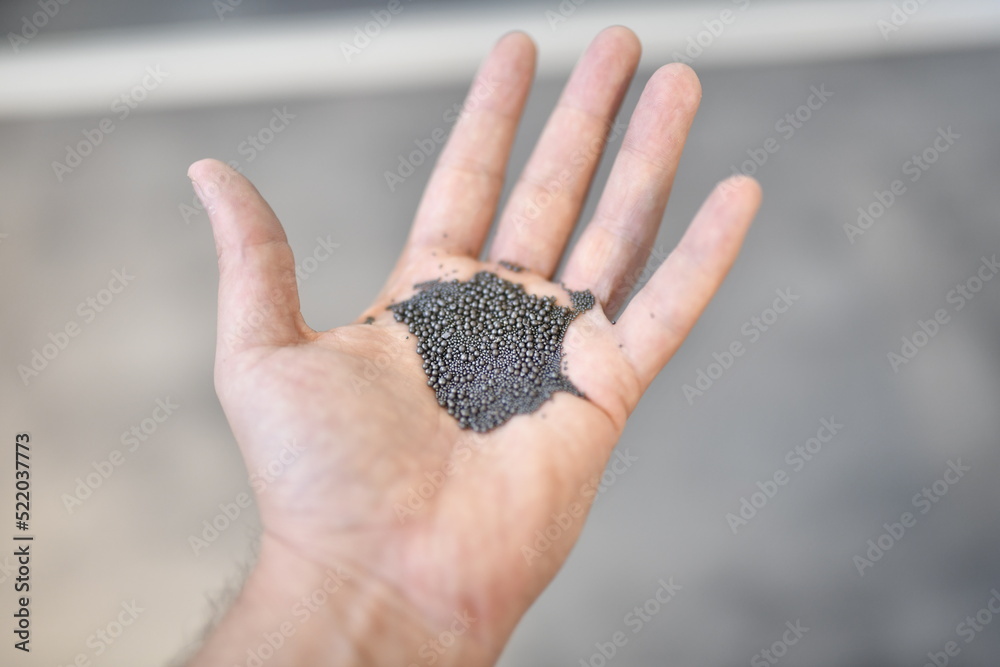 View of the circular steel grits in the palm for abrasive or