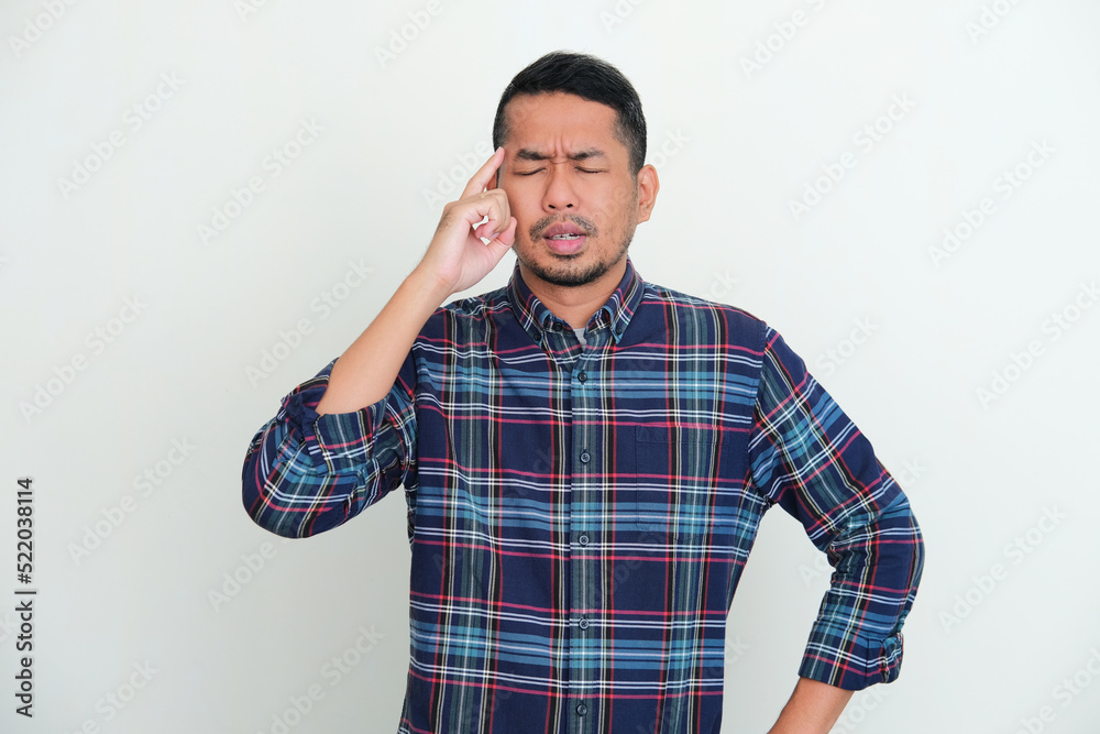 Adult Asian man showing try to remember something gesture Adult Asian man showing try to remember something gesture