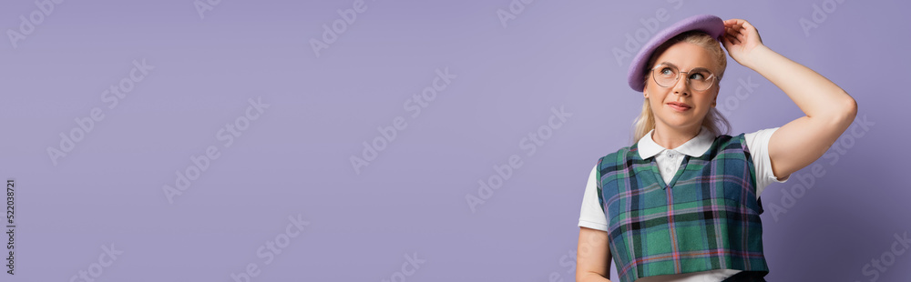 Student in uniform holding beret isolated on purple, banner Student in uniform holding beret isolated on purple, banner