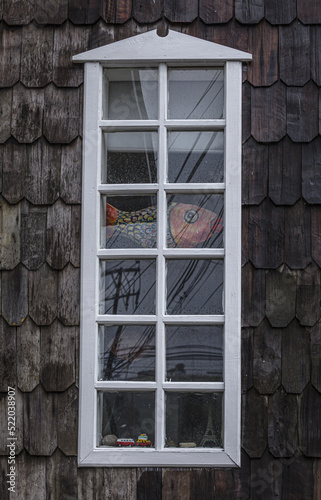 Ventana en palafito tradicional en Castro, Isla de Chiloé, Chile photo