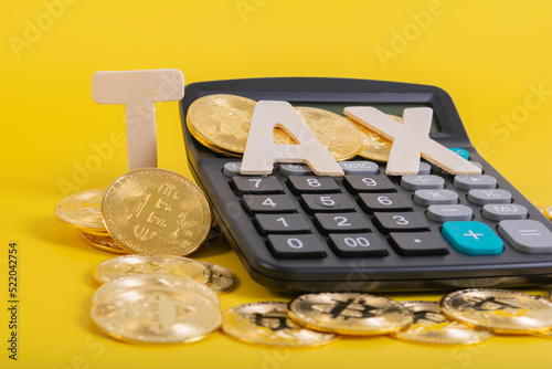 Tax BTC cryptocurrency with TAX wording and calculator on yellow background