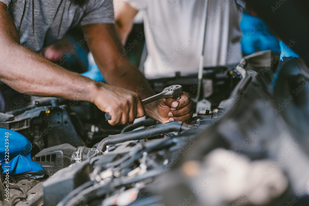 closeup mechanic hand using tool fix service car underhood engine oil replace in auto garace closeup mechanic hand using tool fix service car underhood engine oil replace in auto garace