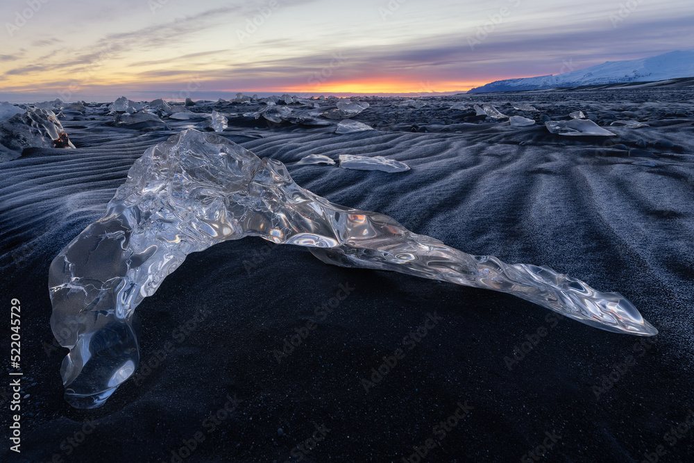 Boomerang shaped ice fragment on black sand beach in Iceland Stock ...
