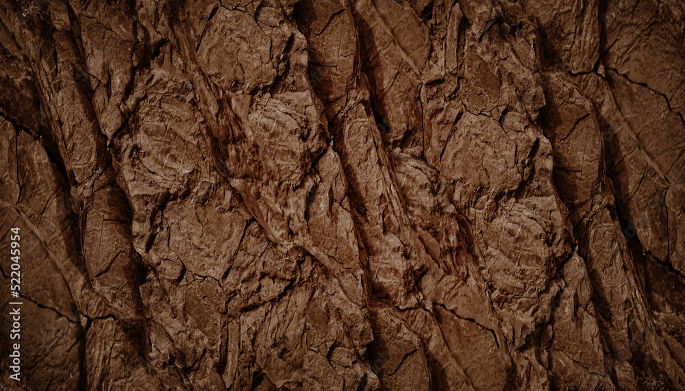 Dark brown rock texture. Rough mountain surface with cracks. Close-up. Stone background with space for design.
