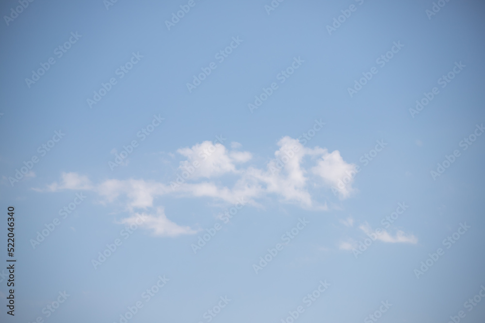 Light blue sky and white clouds. Peaceful sky background. Light blue sky and white clouds. Peaceful sky background.