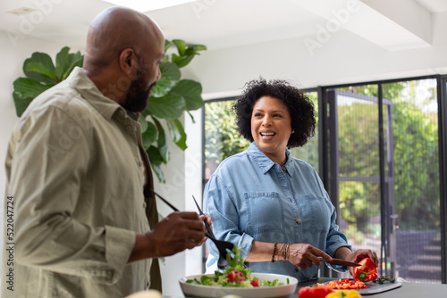 Mature black couple preparing a healthy meal photo