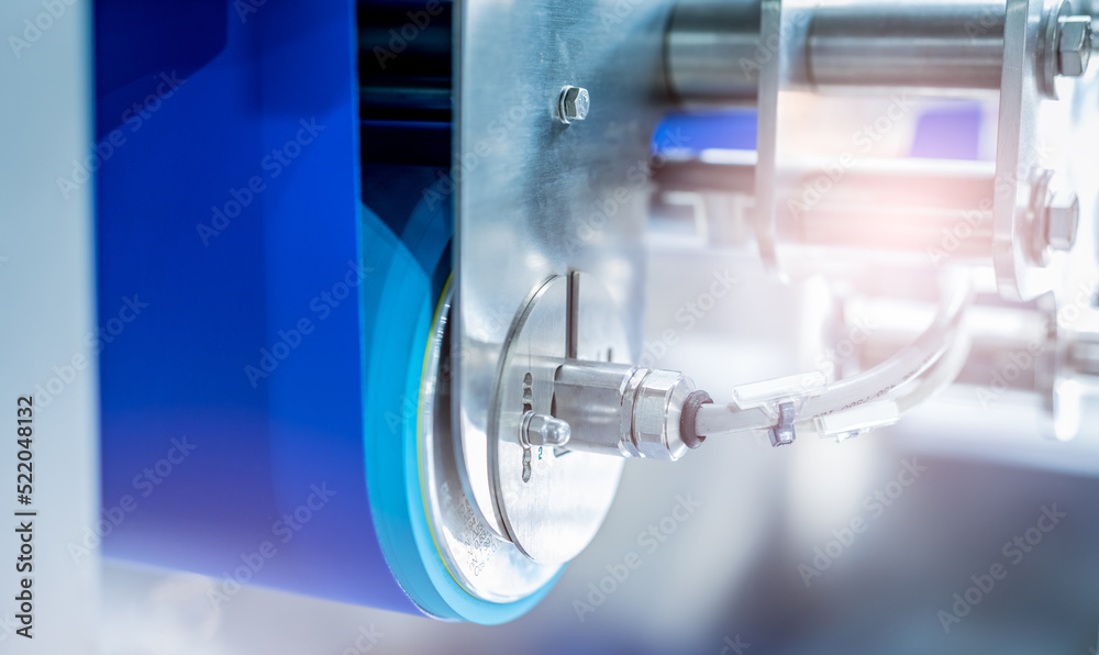 Selective focus on drum motor with blur blue conveyer belt. Electric motor in food factory. Stainless steel roller motor. Food industrial equipment. Industrial gear in food factory. Drum motor working Selective focus on drum motor with blur blue conveyer belt. Electric motor in food factory. Stainless steel roller motor. Food industrial equipment. Industrial gear in food factory. Drum motor working