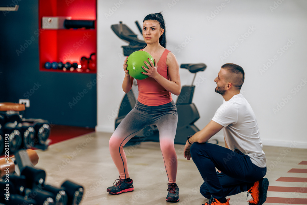 Woman Doing Workout With Coach In The Gym