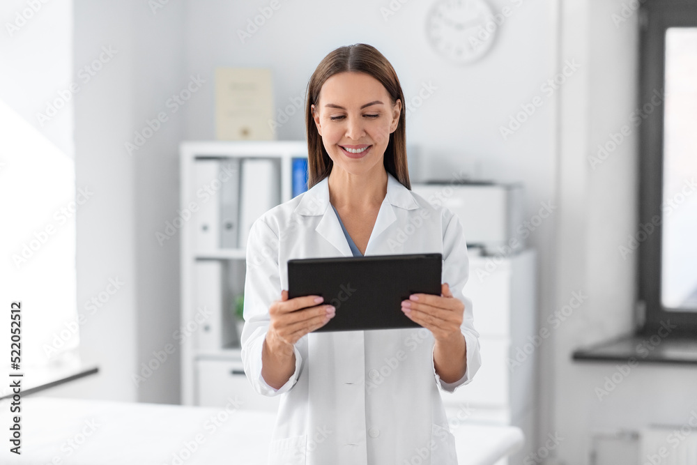 medicine, healthcare and profession concept - smiling female doctor with tablet pc computer at hospital medicine, healthcare and profession concept - smiling female doctor with tablet pc computer at hospital