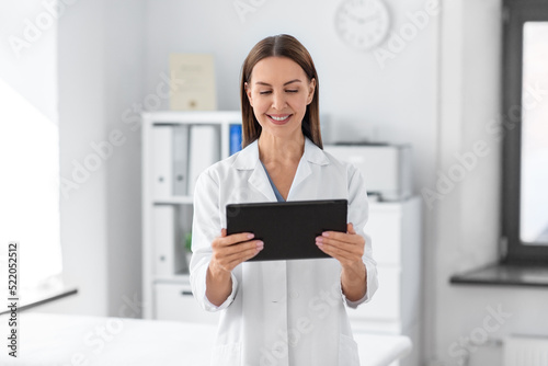 medicine, healthcare and profession concept - smiling female doctor with tablet pc computer at hospital