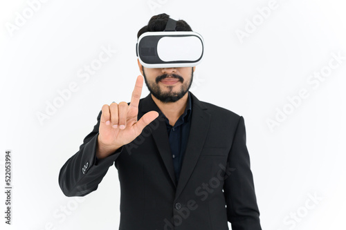 business man in informal suit wearing VR goggles pointing in the air while standing isolated on white background. concept of Metaverse, virtual reality, future, technology, and internet of things.