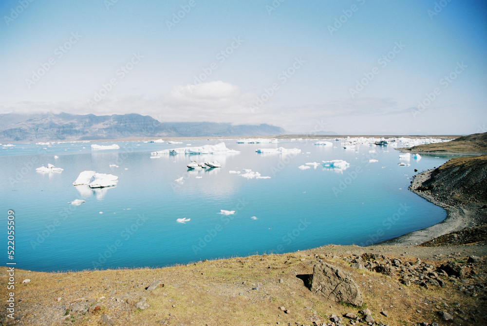 Icebergs in a blue glacial lake in Iceland. Grainy film in the style of old photos. High quality photo