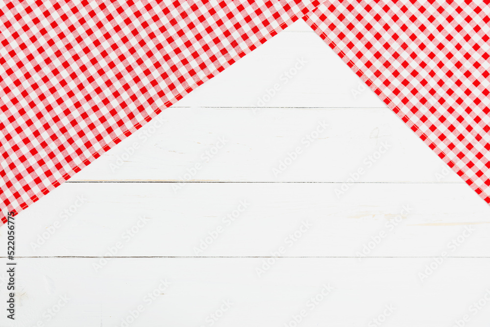Red and white clothes on white background for a menu of a restaurant with copy space. Top view fabric tablecloth on old white wood background. Red and white clothes on white background for a menu of a restaurant with copy space. Top view fabric tablecloth on old white wood background.