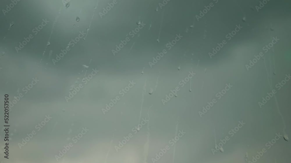 Drops on the apartment window during the rain. Cloudy weather outside, dark clouds. High quality FullHD footage Drops on the apartment window during the rain. Cloudy weather outside, dark clouds. High quality FullHD footage