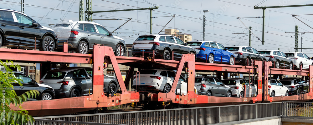 Mane new modern electric and fuel cars transportation by cargo freight train railway wagon. Railroad export and import automotive logistics service. Safety and insurance goods shipping insdustry Mane new modern electric and fuel cars transportation by cargo freight train railway wagon. Railroad export and import automotive logistics service. Safety and insurance goods shipping insdustry