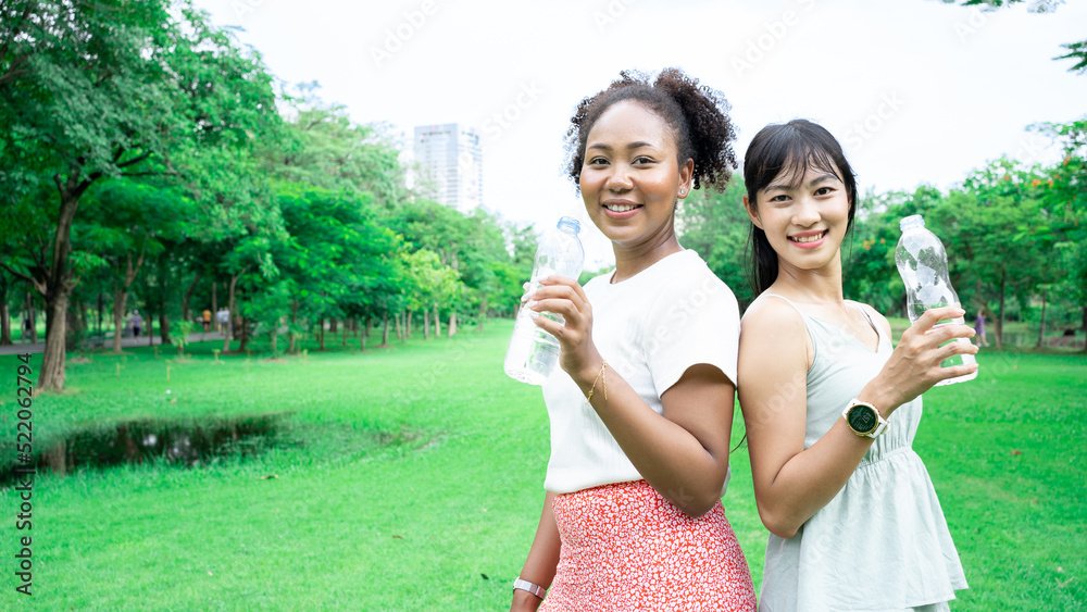 Women Friend Drinking Minerals Water In A Park Diversity Of Charming