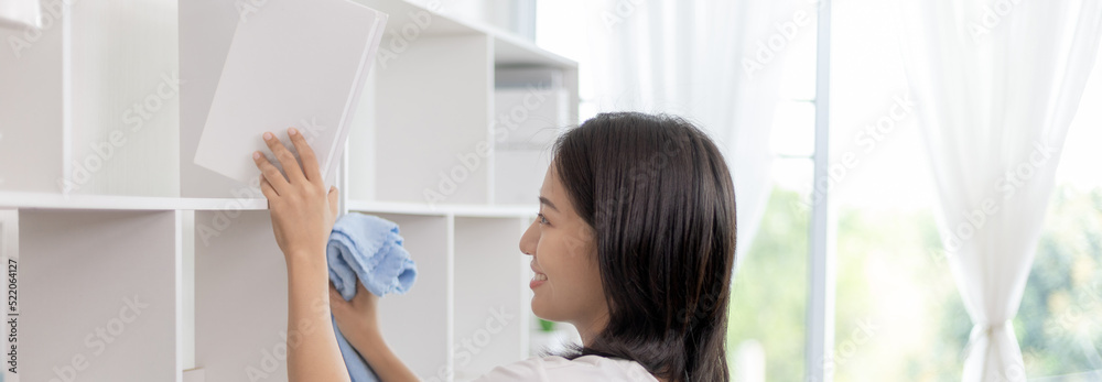 Asian woman housewife cleaning showcase or table, Use alcohol spray to clean and disinfect and wipe with a cloth, Big cleaning, Housework, Daily routine, Remove dust from the table or furniture.