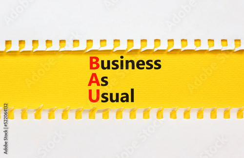 BAU business as usual symbol. Concept words BAU business as usual on yellow paper on a beautiful white background. Business and BAU business as usual concept. Copy space.