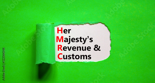 HMRC her majestys revenue and customs symbol. Concept words HMRC her majestys revenue and customs on white paper on beautiful green background. Business HMRC revenue and customs concept. Copy space. photo