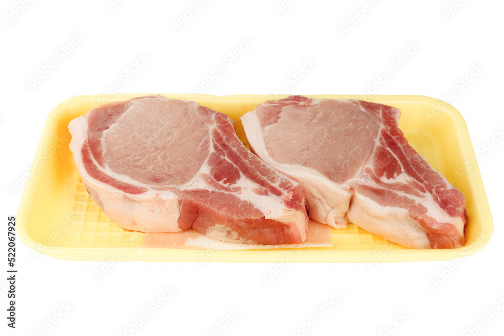 Pork chops in a supermarket package isolated on white background. Side view. Pork chops in a supermarket package isolated on white background. Side view.
