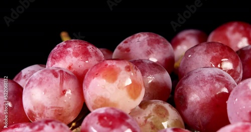 Grapes on a black background. Ripe and organic heap of red grapes rotating on a black background. grapes for wine production. photo