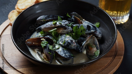 Blue mussels stewed in cream wine sauce with garlic and herbs. Italian or French traditional food