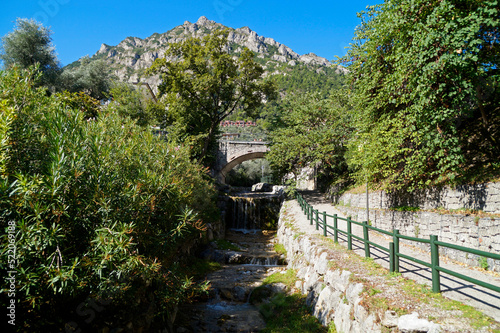 an old stone bridge over the San Giovanni stream  Torrente San Giovanni  in gorgeous green Italian town of Limone sul Garda on lake Garda  Italy  Lombardy   