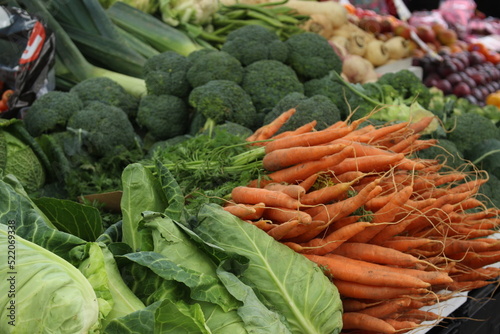Carrots and broccoli at a farmers market.