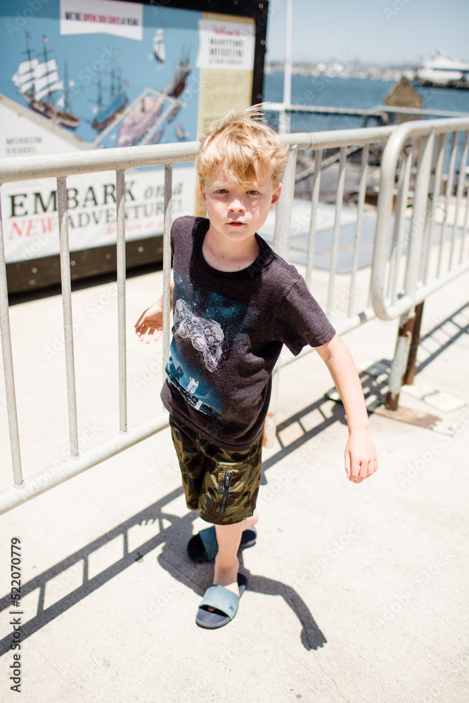 Eight Year Old Boy Waiting Outside Maritime Museum in San Diego Eight Year Old Boy Waiting Outside Maritime Museum in San Diego