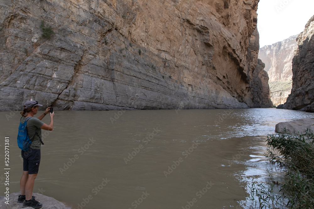 Young woman taking a picture in Canyon in Big Bend National park texas Young woman taking a picture in Canyon in Big Bend National park texas