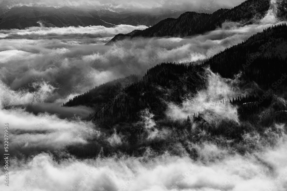 Misty Cloud inversion pushing against mountainside