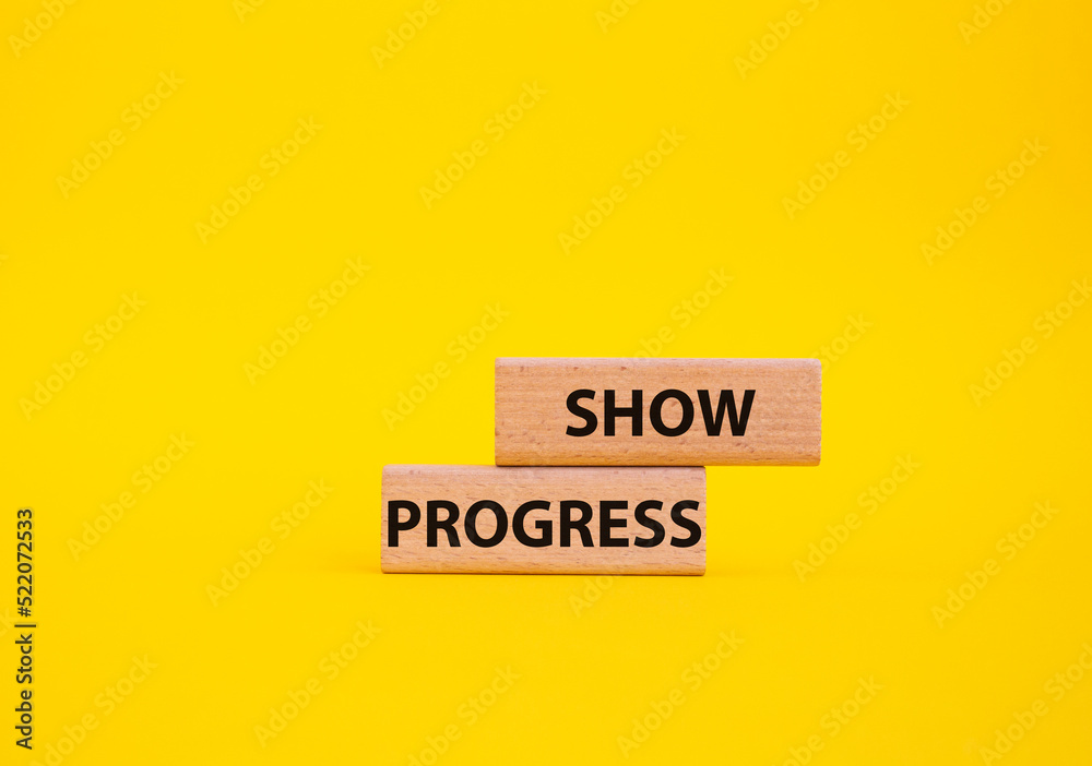 Progress symbol. Wooden blocks with words Show progress. Beautiful yellow background. Business and Show progress concept. Copy space. Progress symbol. Wooden blocks with words Show progress. Beautiful yellow background. Business and Show progress concept. Copy space.