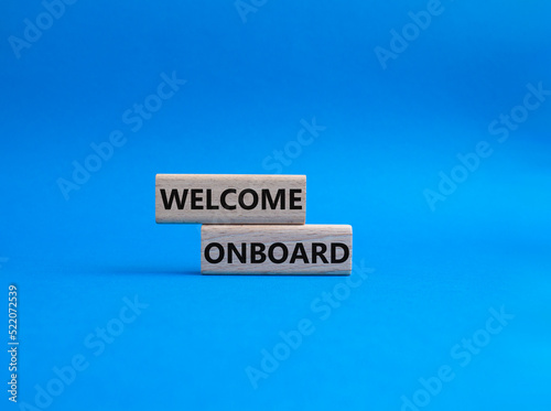 Welcome onboard symbol. Concept words Welcome onboard on wooden blocks. Beautiful blue background. Business and Welcome onboard concept. Copy space.