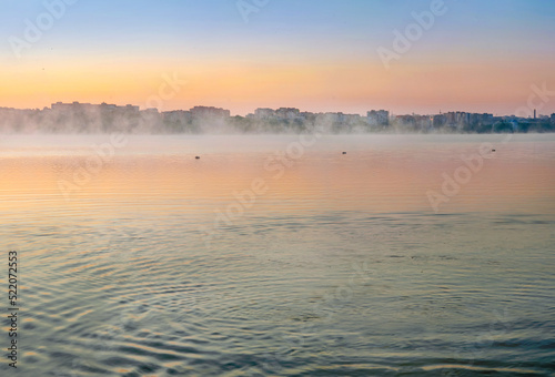 Sun rising above misty lake, the lake in the morning sunrise with fog on the ...