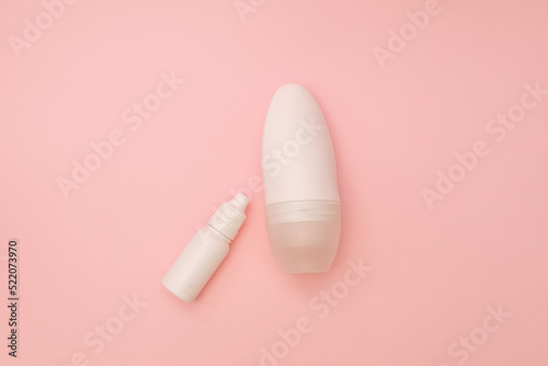 Disoronate and white bottle on a pink background, a subject shot of cosmetics boxes