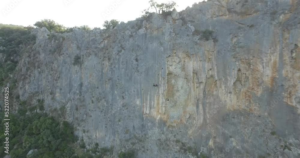 Rock climbing near sea. Climbing to the rock. drone shot Rock climbing near sea. Climbing to the rock. drone shot